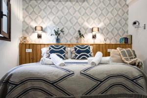 A bed or beds in a room at Edificio Conde 7- Plaza de la Merced