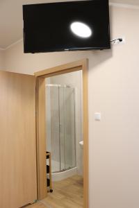 a flat screen tv on the ceiling of a room at Dom Studenta PANS - Akademik, Hostel in Przemyśl