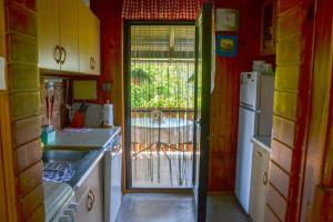 a kitchen with a door that leads to a patio at Romantic Cottage In Real Nature in Radeče