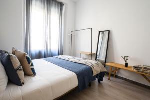 A bed or beds in a room at Edificio Conde 7- Plaza de la Merced