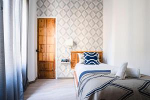 A bed or beds in a room at Edificio Conde 7- Plaza de la Merced
