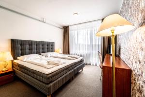 Postel nebo postele na pokoji v ubytování Hotel Fontána