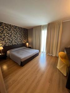Postel nebo postele na pokoji v ubytování Hotel & Residence Castelli