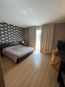Postel nebo postele na pokoji v ubytování Hotel & Residence Castelli