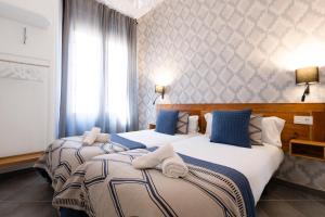 A bed or beds in a room at Edificio Conde 7- Plaza de la Merced