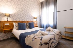 A bed or beds in a room at Edificio Conde 7- Plaza de la Merced