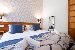 A bed or beds in a room at Edificio Conde 7- Plaza de la Merced