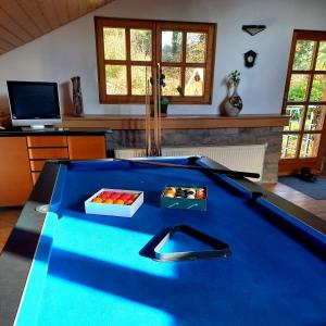 a pool table in a living room with at Le Grand Chalet in La Chapelle