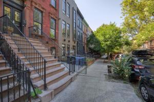 a sidewalk with stairs in front of a building at Park Slope 2BR w WD nr Barclays Center NYC-908 in Brooklyn