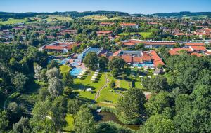 an aerial view of a campus with trees and buildings at Hotel An Der Brunnader - Ihr Zuhause im Rottal in Bad Birnbach