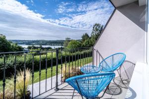 a balcony with two chairs and a view of the water at Hotel Fontána in Brno