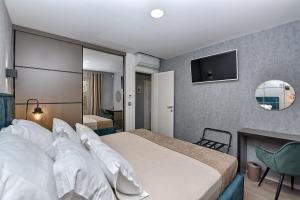 a hotel room with a bed and a television at Art Spa Zeus in Pula +26 photos