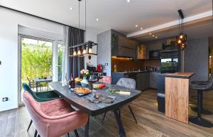 a kitchen and living room with a table with food on it at Art Spa Zeus in Pula
