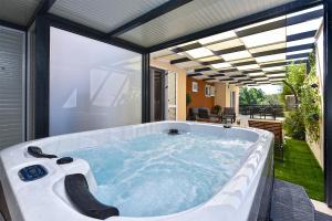 a jacuzzi tub on the patio of a house at Art Spa Zeus in Pula