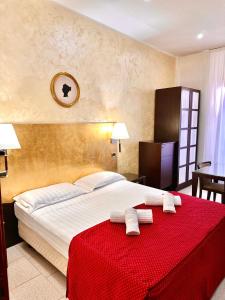 a hotel room with a large bed with two towels at Hotel Fiorella Milano in Milan