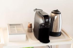 a toaster and a coffee maker on a shelf at Casa degli Ospiti in Alimena