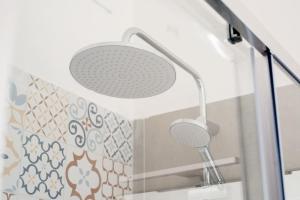 a shower with a shower head in a bathroom at Casa degli Ospiti in Alimena