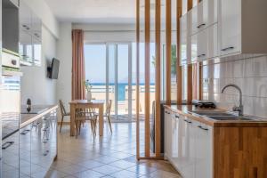 a kitchen with a view of the ocean at Wink Bnb Paraliaki in Kissamos