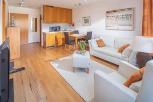 a living room with a white couch and a table at Kleine Möwe 11 in Norderney