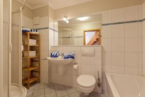 ein Badezimmer mit Toilette, Waschbecken und Badewanne in der Unterkunft Haus Friederike in Norderney + 13 Fotos
