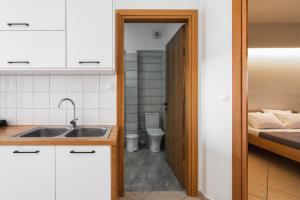 a kitchen with a sink and a bathroom with a bed at Wink Bnb Paraliaki in Kissamos +139 photos