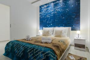 a bedroom with a bed with a large painting on the wall at Apartment Carmen in Trogir