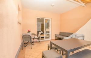 a living room with a table and chairs at Apartment Stella di Mare 2 in Krk +3 photos