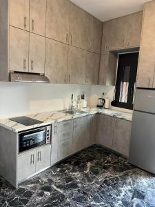 A kitchen or kitchenette at Helios Stays - Sisi Private Apartments