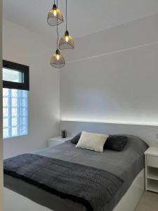 A bed or beds in a room at Helios Stays - Sisi Private Apartments