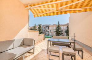 a patio with a table and chairs on a balcony at Apartment Stella di Mare 2 in Krk