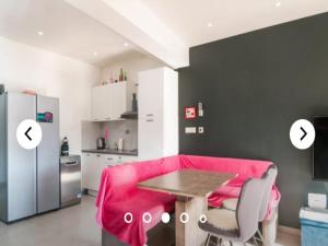 a living room with a pink couch and a table at Apartments Andrea in Solin