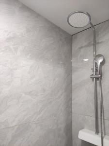a bathroom with a shower with a shower head at Apartments Andrea in Solin