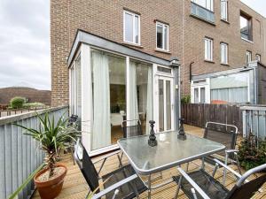 a patio with a table and chairs on a deck at Amazing and 3 bedroom house in Deptford in London