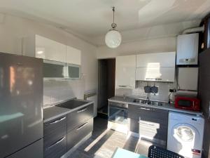 a kitchen with a sink and a dishwasher at Alloggio Sassi in Turin