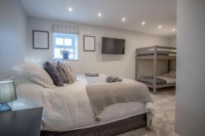 a bedroom with a large bed and a window at The Barn At Kiln Park - 2 Bed Cottage - Narberth in Narberth