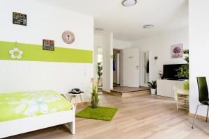 a bedroom with a bed and a living room at Breisach City-Appartements in Breisach am Rhein
