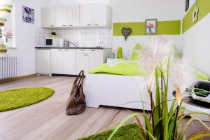 a small bedroom with a bed and a kitchen at Breisach City-Appartements in Breisach am Rhein