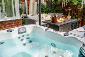 a jacuzzi tub in a backyard with a table at Newmarket Boutique Apartments in Newmarket