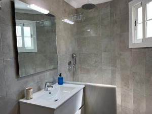 a bathroom with a sink and a mirror and a tub at Apartamentos Jimmy 2 in Nerja