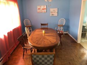 a dining room with a wooden table and chairs at Beach Front on the Bay in our Rustic, Pet Friendly Cottage home in North Camellia Acres