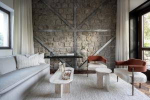 a living room with a couch and two chairs at Pereh Mountain Resort in Gadot