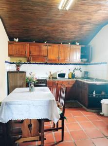 a kitchen with a table with a white table cloth at Casa da Fonte - Branda da Aveleira in Melgaço