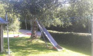 a slide in a playground in a park at Ferienwohnung Petersen-Kröger in Gelting
