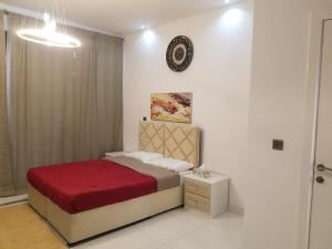 a bedroom with a bed and a clock on the wall at Spacious 3BR Townhouse Villa in Dubai