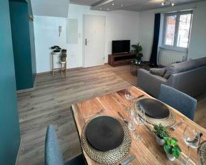 uma sala de estar com uma mesa e um sofá em Sur la route des vins entre Colmar et Strasbourg em Scherwiller