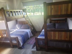 a bedroom with two bunk beds and a window at Villa Diosa in Jarabacoa