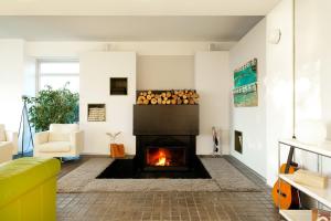 a living room with a fireplace and a yellow couch at Hotel A Miranda in Feás