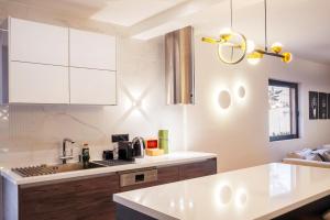 a kitchen with white cabinets and a sink at EcoStay - Infinity business class 2BDR apartment by the sea in Alimos in Athens