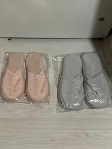 two pairs of pink shoes in a plastic bag at Suit tuzla in Tuzla