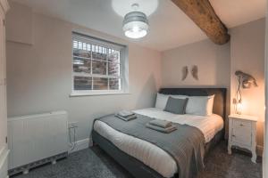 a bedroom with a bed and a window at Clarence Street Town House in Liverpool